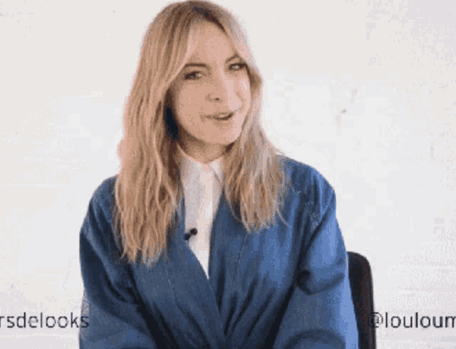a woman wearing a blue jacket and a white shirt with the words rsdelooks on the bottom
