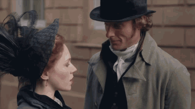 a man wearing a top hat and a woman wearing a black hat look at each other
