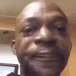 a close up of a man 's face with a tear running down his face .