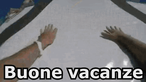 a person 's hands are reaching out towards a snowy surface with the words buone vacanze in the background .