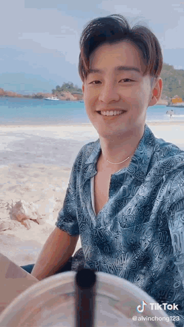 a young man is taking a picture of himself on the beach with a hashtag that says tiktok