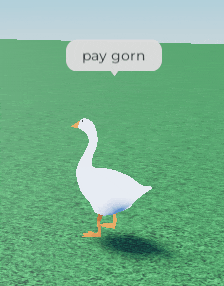 a white goose is walking in a field with a pay gorn speech bubble above it