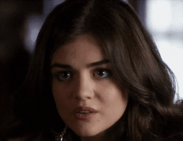 a close up of a woman 's face with brown hair
