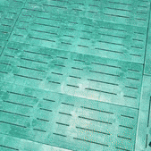 a person sitting on a green tile floor