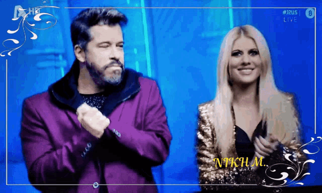 a man in a purple suit and a woman in a gold sequined jacket are standing next to each other on a blue background
