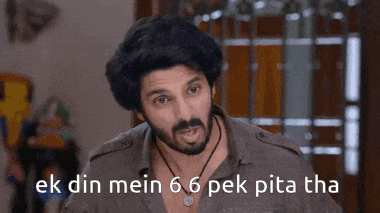 a man with a beard and mustache is making a funny face and says ek din mein 6 6 pek pita tha .