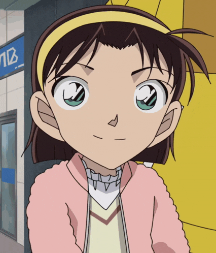 a girl in a pink jacket stands in front of a building with a sign that says nb on it