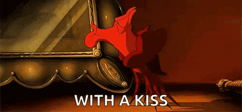a cartoon character is standing in front of a mirror with the words `` with a kiss '' written on the bottom .