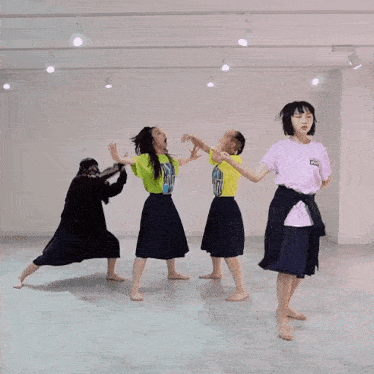 a girl wearing a pink shirt that says ' i love you ' on it dances with three other girls