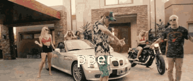 a group of people dancing in front of a car that says pper on it