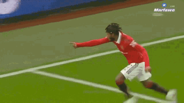 a soccer player in a red shirt with the number 26 on it