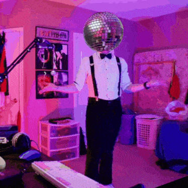 a person with a disco ball on their head in a room