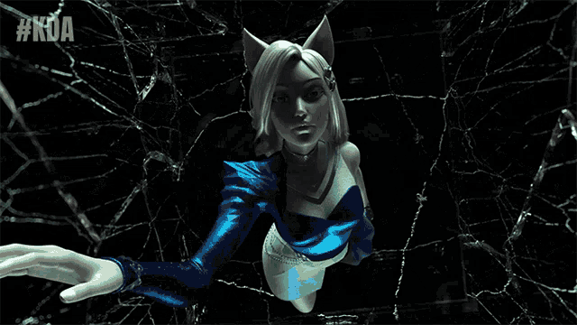 a woman in a blue top is standing in a dark room with #kda written on the bottom right