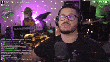 a man wearing glasses and headphones talks into a microphone on a twitch channel
