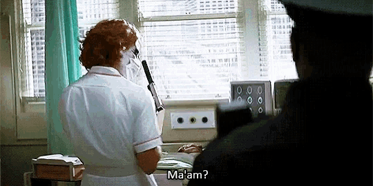 a nurse is talking to a police officer in a hospital room and says malam