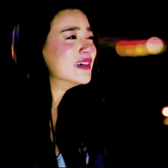 a woman with a tear running down her face