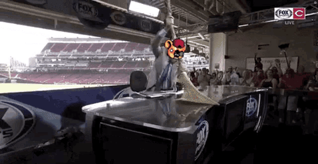 a fox live broadcast of a baseball game being played in a stadium