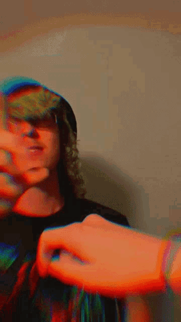 a blurry picture of a person 's face with a hand covering it