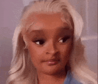 a close up of a woman 's face with blonde hair .