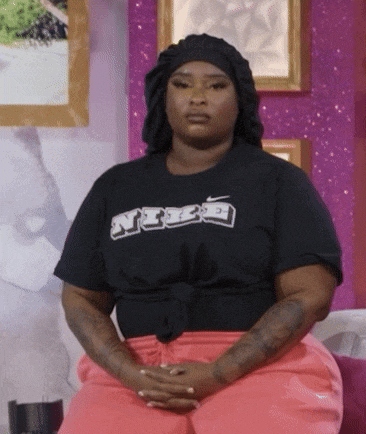 a woman wearing a black nike t-shirt and pink sweatpants