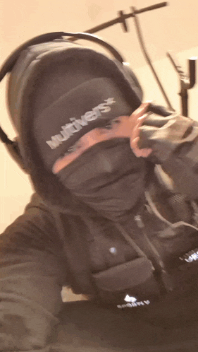 a person wearing headphones and a hat with the word multiverse on it