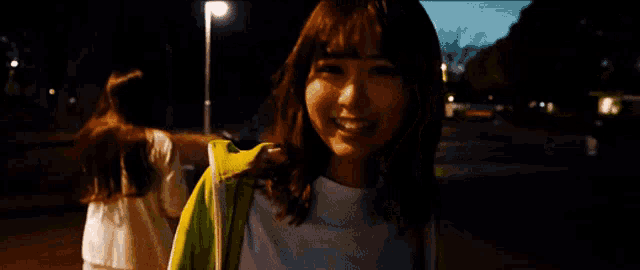 a woman wearing a yellow jacket with white stripes