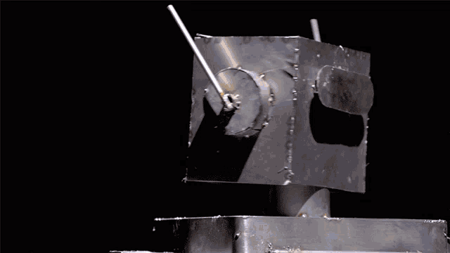 a close up of a piece of metal with nuts and washers