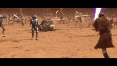 a man is holding a lightsaber in front of a group of people .