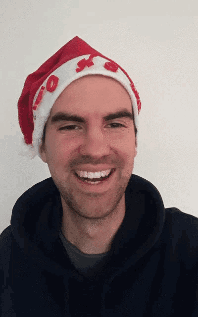 a man wearing a santa hat with the letters io written on it