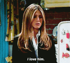 a woman says " i love him " while standing in front of a refrigerator