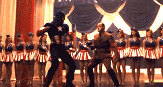 a man in a captain america costume is dancing with a man in a military uniform