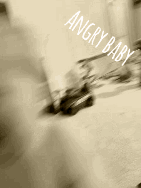 a blurry picture of a car with the words angry baby above it