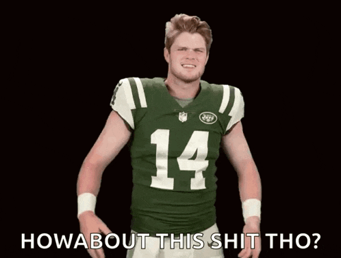 a man wearing a jets jersey with the number 14 on it