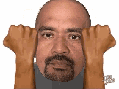 a man with a beard is making a funny face with his hands