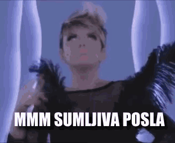 a woman in a black dress with feathers on her wings says mmmm sumljiva posla
