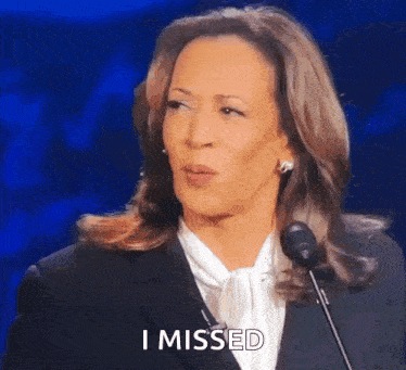 a woman is speaking into a microphone and says i missed