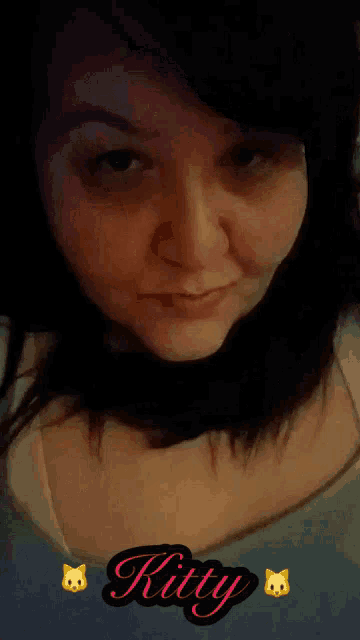 a close up of a woman 's face with the word kitty written on it