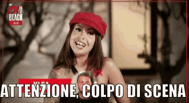 a woman wearing a red hat is holding a picture of a man .