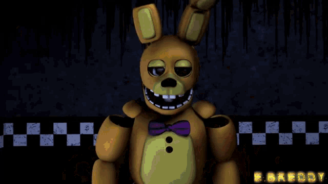 a yellow stuffed animal with a purple bow tie and the word freddy on the bottom right