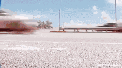 a blurry picture of a car driving down a street with the words historymiami written on the bottom