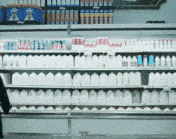 a grocery store aisle filled with lots of milk bottles