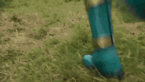 a blurry picture of a person in a green outfit running