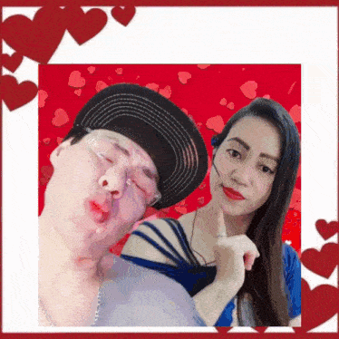 a man and a woman are posing for a picture with red hearts behind them
