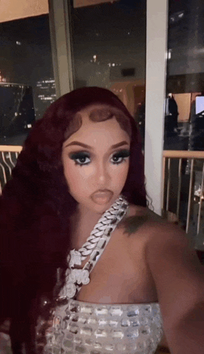 a woman with red hair is taking a selfie
