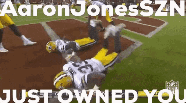 a green bay packers player is laying on the ground