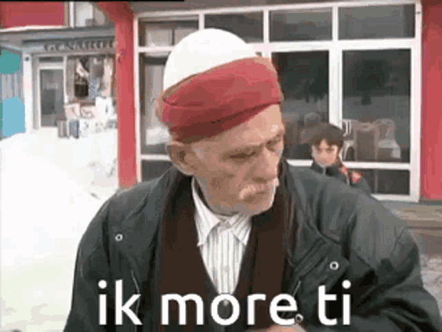 an elderly man wearing a red and white turban says ik more ti