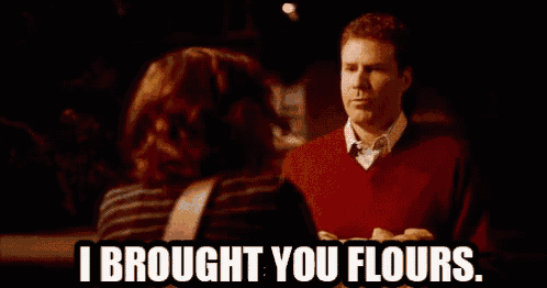 a person holding a cardboard box that says i brought you flours on it