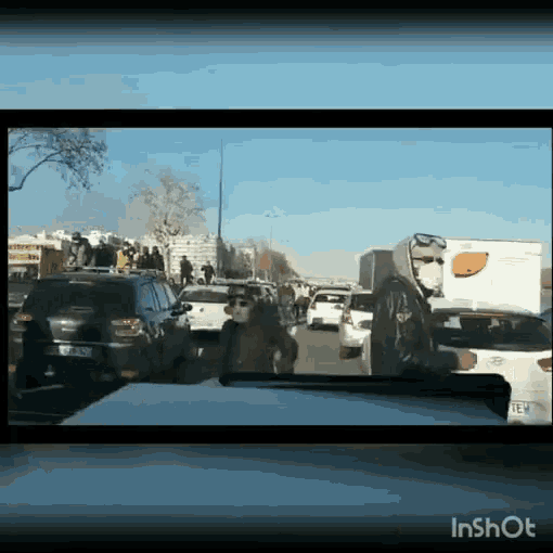 a screen shot of a busy street with the words inshot on the bottom