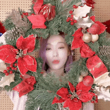 a woman with purple hair is surrounded by a christmas wreath .