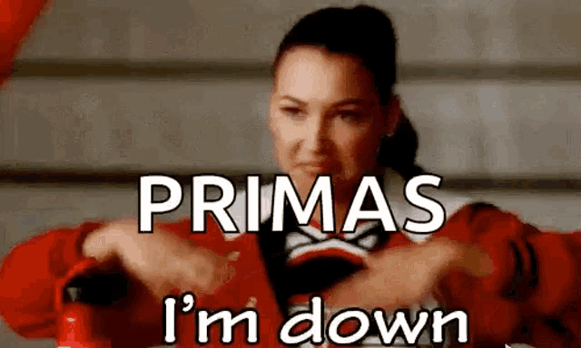 a cheerleader is saying primas i 'm down in a red jacket .